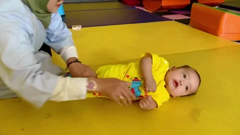 Physiotherapist with infant boy Stock Footage 326842244