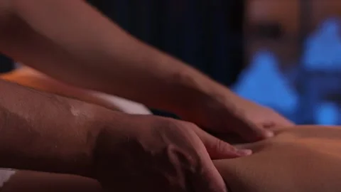 A physiotherapist massages a problem area of a visitor's back, a therapeutic Video stock 249091767
