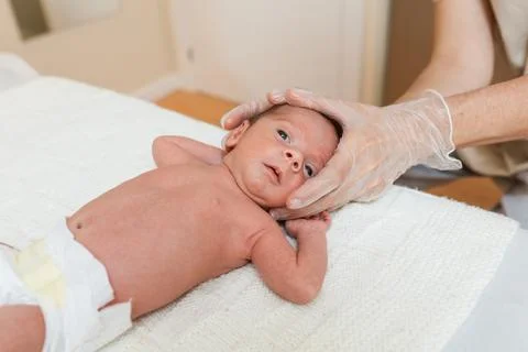 Physiotherapist performing coronal suture work on a newborn baby in a therapy Stock Photos