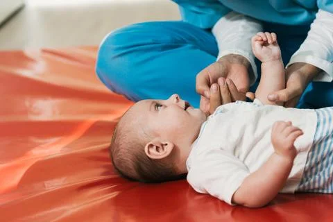 Physiotherapist performing exercises on a five month old baby Stock Photos