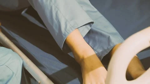 Physiotherapist performing a knee exercise for a patient Stock Footage 325966695
