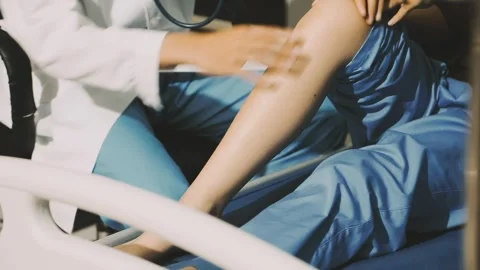 Physiotherapist performing a knee exercise for a patient Stock Footage 325966706