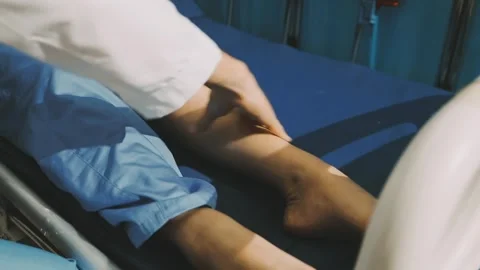 Physiotherapist performing a knee exercise for a patient Stock Footage 325966719
