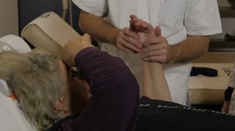 Physiotherapist showing and doing exercises for rehabilitation hand of old woman Stock Footage 59525802