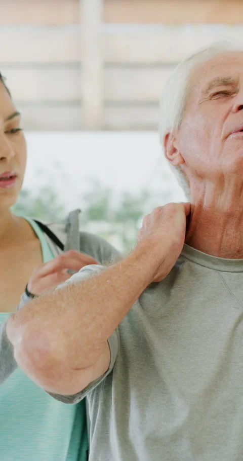 Physiotherapist, support and old man in clinic with neck pain, rehabilitation Stock Footage 334935597