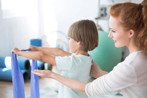 Physiotherapist supporting kid 스톡 사진