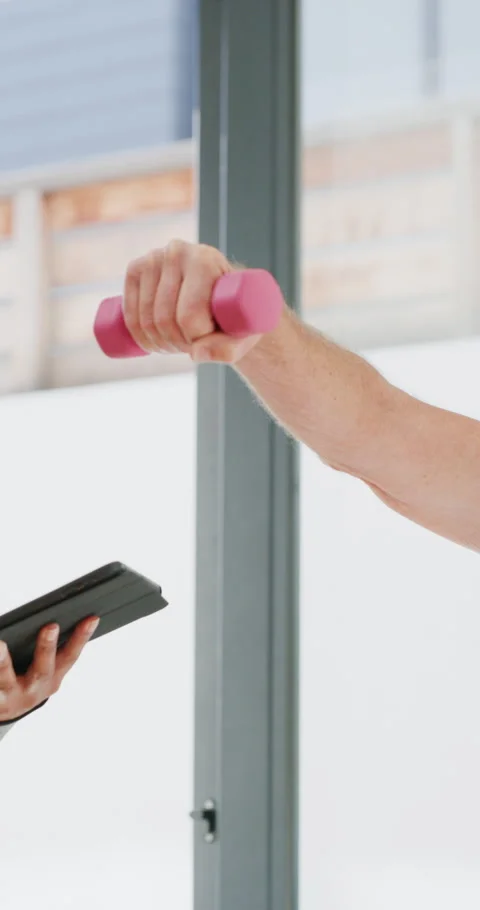 Physiotherapist, tablet and old man exercise with dumbbells for fitness Stock Footage 334922087