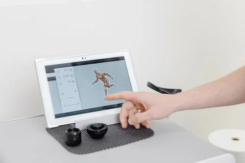 Physiotherapist using tablet computer with human anatomy application Stock Photos