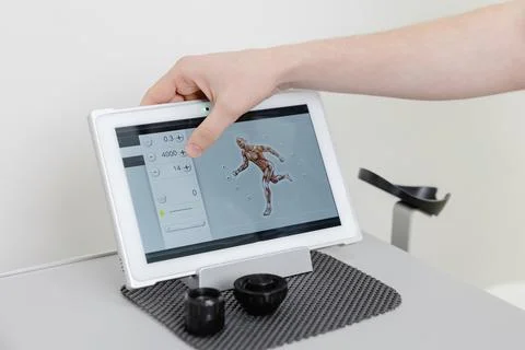 Physiotherapist using tablet computer with human anatomy application Stock Photos