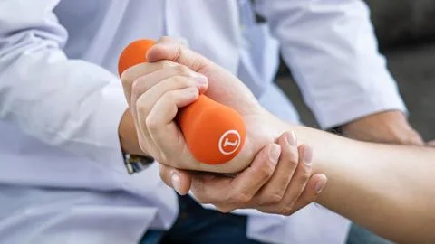 Physiotherapist working with patient doing with exercise, physical therapy co Stock Photos