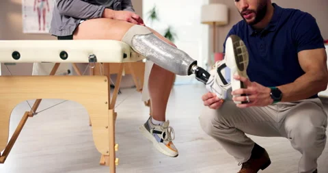 Physiotherapy, amputee and leg with people and help for person with a disability Stock Footage 283592753