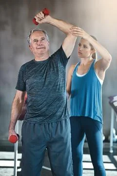 Physiotherapy, dumbbell and fitness with old man and personal trainer for Stock Photos
