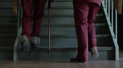 Physiotherapy - Teaching to walk with cane on stairs Stock Footage 64872997