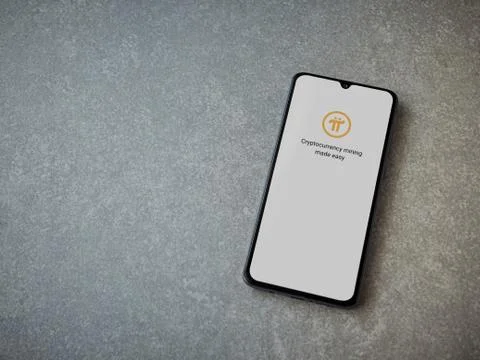 Pi Network app launch screen with logo on the display of a black mobile smart Stock Photos