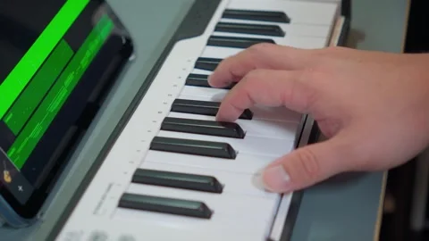 Pianist hands composing music on compact digital synthesizer keyboard Video stock 338043703