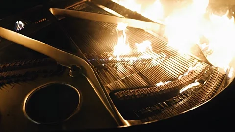 The piano is on fire and a fire has broken out inside it Stock Footage 339304535