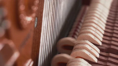 Piano hammers hitting on strings inside upright piano close up Stock Footage 139093767