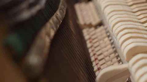 Piano hammers knock on strings, close-up from inside. Concept of the device of Stock Footage 151097570