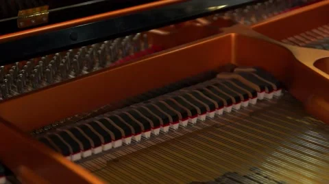Piano hammers strike the strings. Stock Footage 48487401
