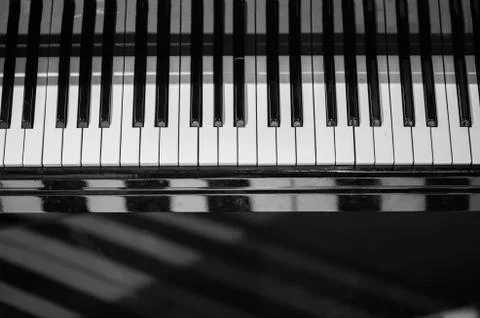 Piano keyboard background with selective focus. Blur keyboard and musical notes Stock Photos