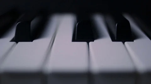 Piano keys on a dark background in motion Stock Footage 76946976