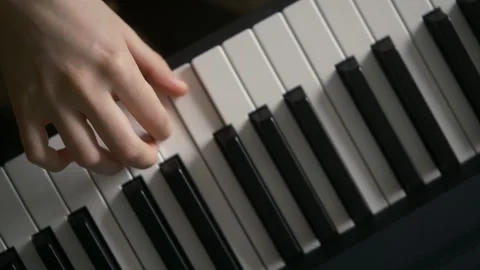 Piano lessons top view,  Close up teenagers  hands playing the piano Video stock 314989329