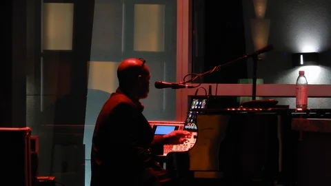 Piano Man Singer At Bar Preparing Next Piece With Computerized Equipment And Stock Footage 128312432