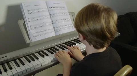 Piano played by cute boy Video stock 45621398