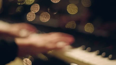 Piano Player Hands In front of Christmas Holiday Tree and Lights Bokeh Stock Footage 321376953
