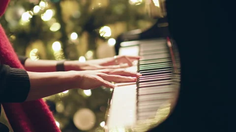 Piano Player Hands In front of Christmas Holiday Tree and Lights Bokeh Stock Footage 321376972