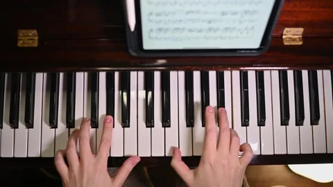 Piano practice. Modern technologies and ancient musical instruments. Stock Footage 262970238