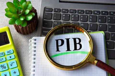 PIB acronym in notebook under magnifying glass with laptop and calculator in  Stock Photos