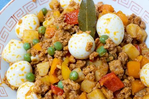 Picadillo with quail eggs Stock Photos