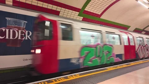 Picadilly line vandalised underground train enters Picadilly Circus Station Stock Footage 314420130