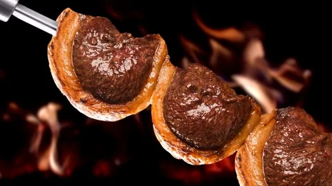Picanha, traditional Brazilian barbecue with fire background. Stock Footage