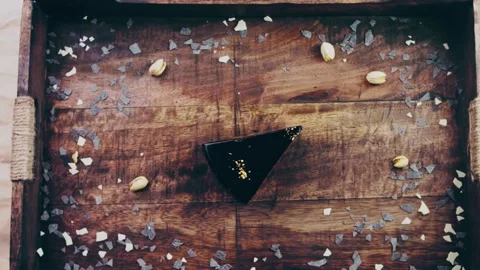 Picasso effect of Banana chocolate cake with gold dust on a wooden tray with Stock Footage 231905562