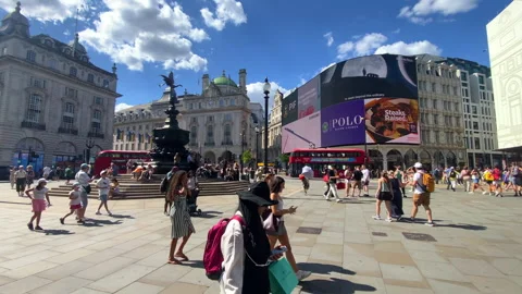 Piccadilly Circus with its iconic screens and busy streets in London Stock Footage 320297761