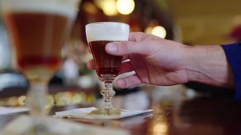 Pick Up and Drink Irish Coffee Close Up with Bartender in Back Video stock 101446209