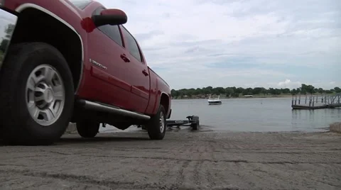 Pick up backs down boat ramp with trailer Stock-Footage 43897976