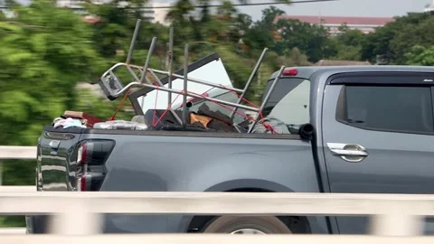 The pick-up car full loaded of household goods ride on the road Video stock 273661018
