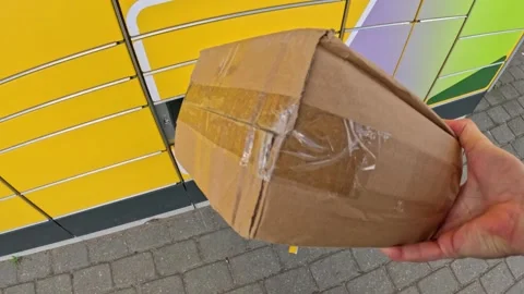 Pick up cardboard box from yellow post machine, POV view Stock Footage 309568180