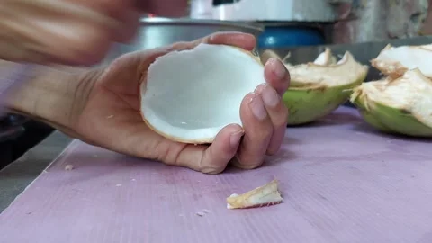 Pick the coconut meat from the fruit Stock Footage 261176789
