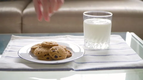Pick up the cookies from the white plate Stock Footage 147962093