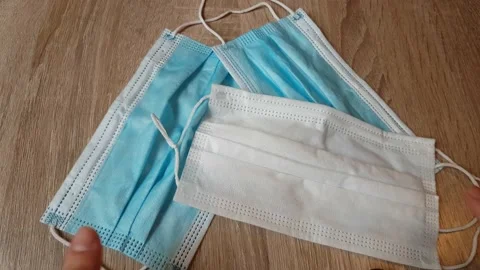 Pick up mask on the table. Video stock 130400722