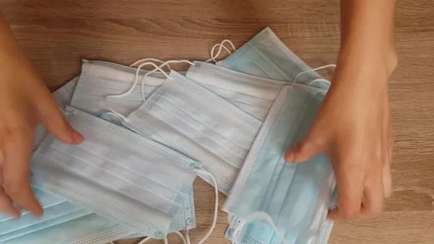 Pick up mask on the table. Video stock 136957578