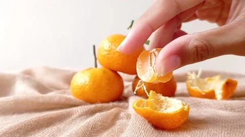 Pick one orange on a brown table Stock Footage 146259988