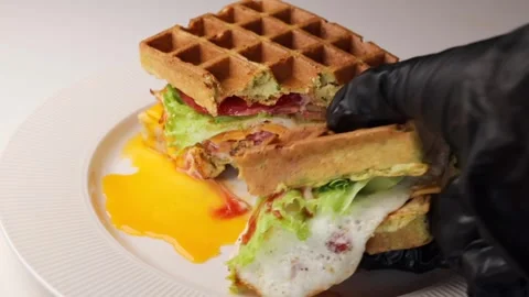 Pick up a piece of the burger waffle with hands in black silicone gloves. Stock Footage 294564514