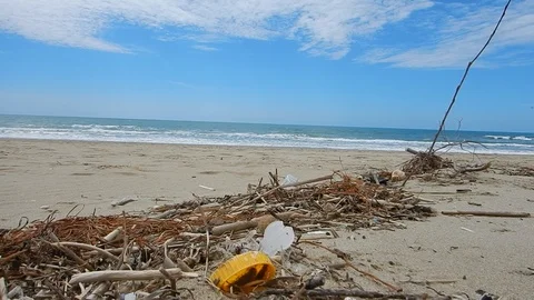 Pick up plastic pieces found on the beach to help environment 4543 Stock Footage 107950751