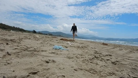 Pick up plastic pieces found on the beach to help environment 4611 Stock Footage 107951062