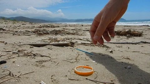 Pick up plastic pieces found on the beach to help environment 4613 Stock Footage 107951103